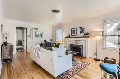 a living room with a white couch and a fireplace at Cozy Duplex near Hospitals and Cherry Creek in Denver in Denver