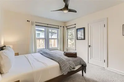 a bedroom with a bed and a ceiling fan at Cozy Duplex near Hospitals and Cherry Creek in Denver in Denver