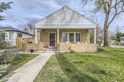 a small brick house with a red door at Cozy Duplex near Hospitals and Cherry Creek in Denver in Denver