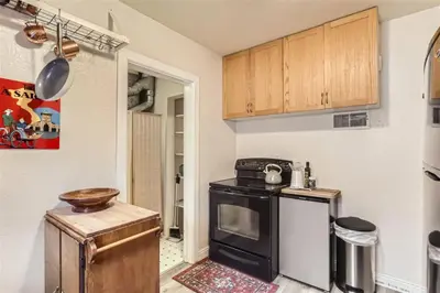 a kitchen with a black stove and a counter at Cozy Duplex near Hospitals and Cherry Creek in Denver in Denver