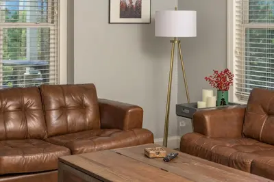 a living room with two brown leather couches and a table at Luxe 4BR Mtn Retreat With Stunning Views Near Ski AndHikes in Nederland