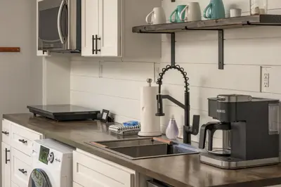 a kitchen with a sink and a coffee maker at Luxe 4BR Mtn Retreat With Stunning Views Near Ski AndHikes in Nederland