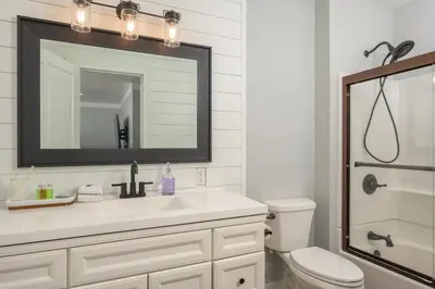 a bathroom with a sink and a toilet and a mirror at Luxe 4BR Mtn Retreat With Stunning Views Near Ski AndHikes in Nederland