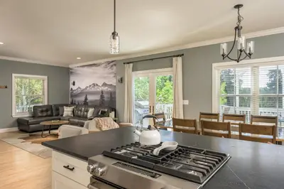 a kitchen and living room with a stove top at Luxe 4BR Mtn Retreat With Stunning Views Near Ski AndHikes in Nederland