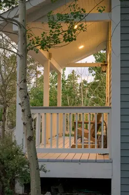 a porch of a house with a table on it at Luxe 4BR Mtn Retreat With Stunning Views Near Ski AndHikes in Nederland