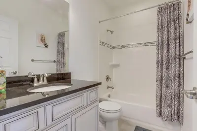 a white bathroom with a sink and a toilet at Beautiful New Townhome in Denver