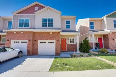 a house with a car parked in front of it at Beautiful New Townhome in Denver