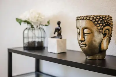 a shelf with a statue of a head and a vase at Beautiful New Townhome in Denver