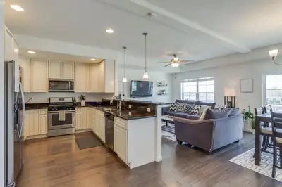 an open kitchen and living room in a home at Beautiful New Townhome in Denver