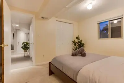 a bedroom with a large bed and a window at Backyard Oasis Pool Is A Beautiful Home in Arvada