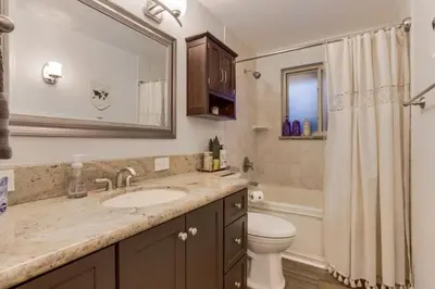 a bathroom with a sink and a toilet and a tub at Backyard Oasis Pool Is A Beautiful Home in Arvada