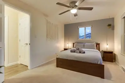 a bedroom with a bed with a ceiling fan at Backyard Oasis Pool Is A Beautiful Home in Arvada