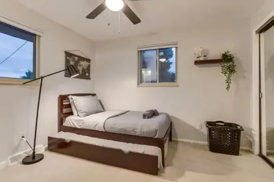 a bedroom with a bed and a ceiling fan at Backyard Oasis Pool Is A Beautiful Home in Arvada