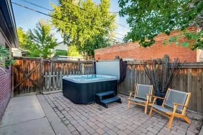 a backyard with a hot tub and two chairs at The Bonsai Bungalow With A Hot Tub And A Game Room in Denver
