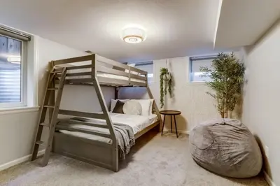 a bedroom with a bunk bed with a ladder at The Bonsai Bungalow With A Hot Tub And A Game Room in Denver