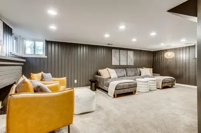 a living room with a couch and chairs at The Bonsai Bungalow With A Hot Tub And A Game Room in Denver