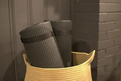 a wicker basket filled with books on a wall at The Bonsai Bungalow With A Hot Tub And A Game Room in Denver