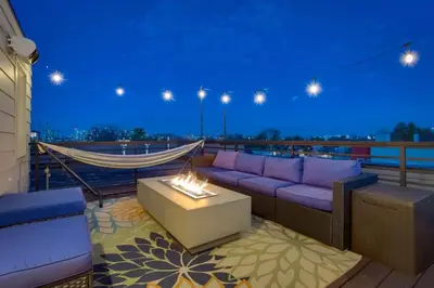 a living room with a couch and a fire pit at Modern And Spacious Townhouse Blocks from Downtown in Denver