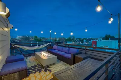 a balcony with purple couches and a fire pit at Modern And Spacious Townhouse Blocks from Downtown in Denver