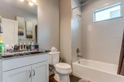 a bathroom with a toilet and a sink and a tub at Modern And Spacious Townhouse Blocks from Downtown in Denver