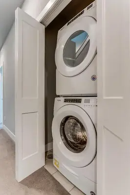 a laundry room with a washing machine and a washer at Modern And Spacious Townhouse Blocks from Downtown in Denver