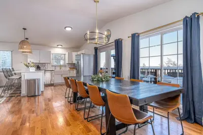 a kitchen and dining room with a large table and chairs at Mountain Top Getaway With A Hot Tub in Morrison