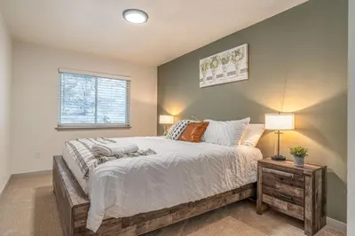 a bedroom with a large bed and a window at Mountain Top Getaway With A Hot Tub in Morrison