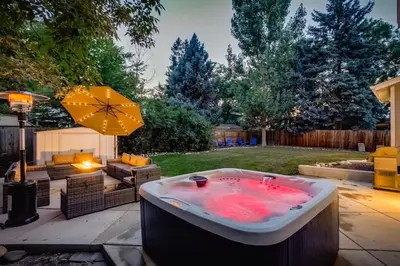 a jacuzzi tub in the backyard of a yard at A Great Location Modern Home With A Hot Tub in Arvada