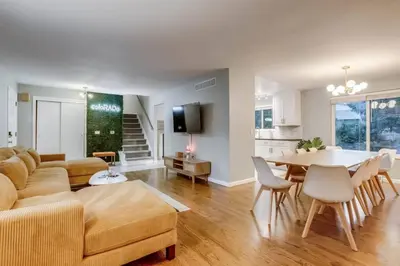 a living room with a couch and a table at A Great Location Modern Home With A Hot Tub in Arvada