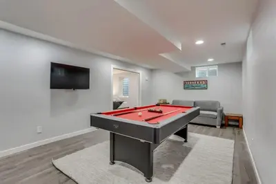 a living room with a red pool table in it at A Great Location Modern Home With A Hot Tub in Arvada