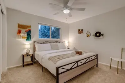 a bedroom with a bed and a ceiling fan at A Great Location Modern Home With A Hot Tub in Arvada