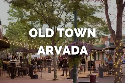 a sign that reads old town avoriaza with people sitting at tables at A Great Location Modern Home With A Hot Tub in Arvada