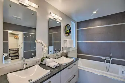 a bathroom with two sinks and a large mirror at Skyline House An Eco Efficient Luxury Home in Denver