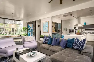 a living room with purple and blue pillows at Skyline House An Eco Efficient Luxury Home in Denver