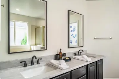 a bathroom with two sinks and a large mirror at Artist Getaway In Downtown Westminster in Westminster