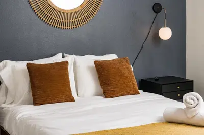 a bedroom with a bed with white sheets and pillows at Artist Getaway In Downtown Westminster in Westminster