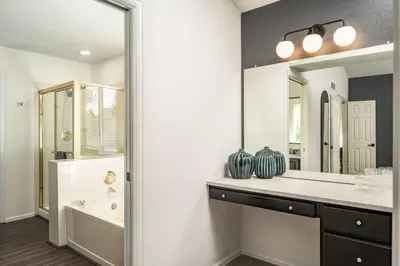 a bathroom with a sink and a tub and a mirror at Artist Getaway In Downtown Westminster in Westminster