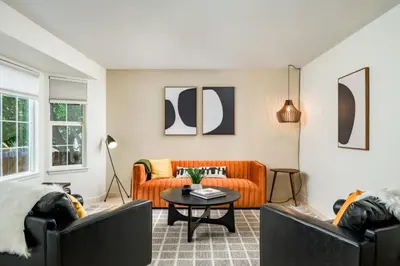 a living room with two couches and a table at Artist Getaway In Downtown Westminster in Westminster