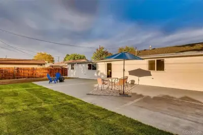 a patio with a table and an umbrella at Near Downtown Denver A Huge Home With Two Kitchens in Denver