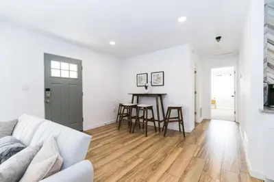 a white living room with a white couch and a table at Near Downtown Denver A Huge Home With Two Kitchens in Denver