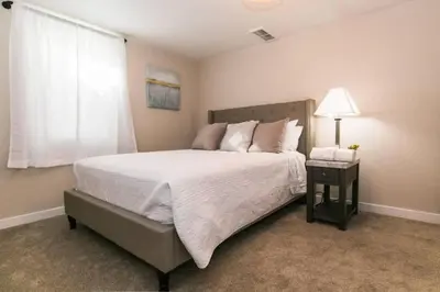 a bedroom with a large bed and a window at Near Downtown Denver A Huge Home With Two Kitchens in Denver