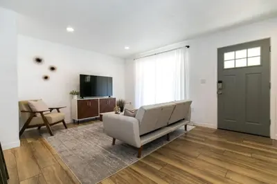 a living room with a couch and a tv and a door at Private Chic 2 Bathroom 10 min to Downtown With Fast Wifi in Denver