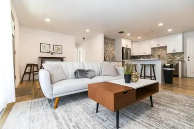 a living room with a white couch and a table at Private Chic 2 Bathroom 10 min to Downtown With Fast Wifi in Denver