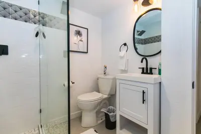 a bathroom with a toilet and a sink and a mirror at Cozy With 2 Bath 10 min to Downtown Denver And Fast Wifi in Denver