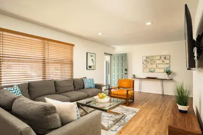 a living room with a couch and a table at The MCM Movie Manor With A Big Backyard And A Movie Theater in Arvada