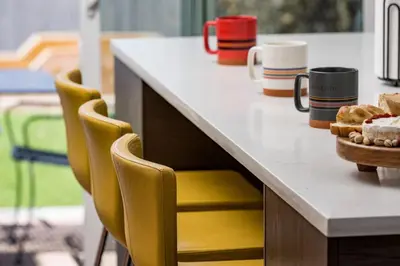 a counter with chairs and cups and a table with cookies at The MCM Movie Manor With A Big Backyard And A Movie Theater in Arvada