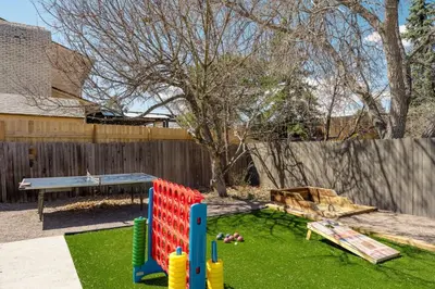 a playground in a backyard with a wooden fence at The MCM Movie Manor With A Big Backyard And A Movie Theater in Arvada