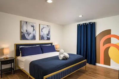 a bedroom with a bed with a teddy bear sitting on it at The MCM Movie Manor With A Big Backyard And A Movie Theater in Arvada