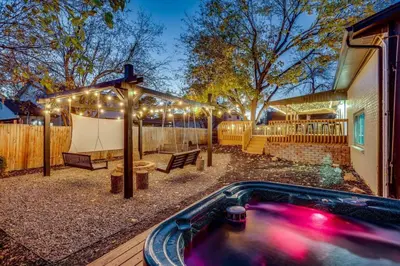 a backyard with a hot tub and a tent with lights at Games Gone Wild Between Red Rocks And Downtown Denver In Arvada in Arvada