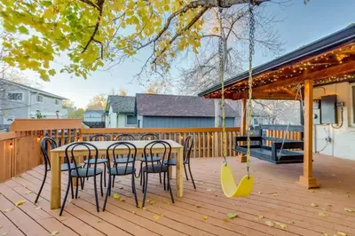 a patio with a table and chairs and a swing at Games Gone Wild Between Red Rocks And Downtown Denver In Arvada in Arvada